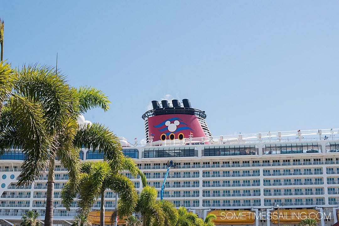 Photo of the red stack of a Disney Cruise Line ship with a Mickey Mouse head silhouette.