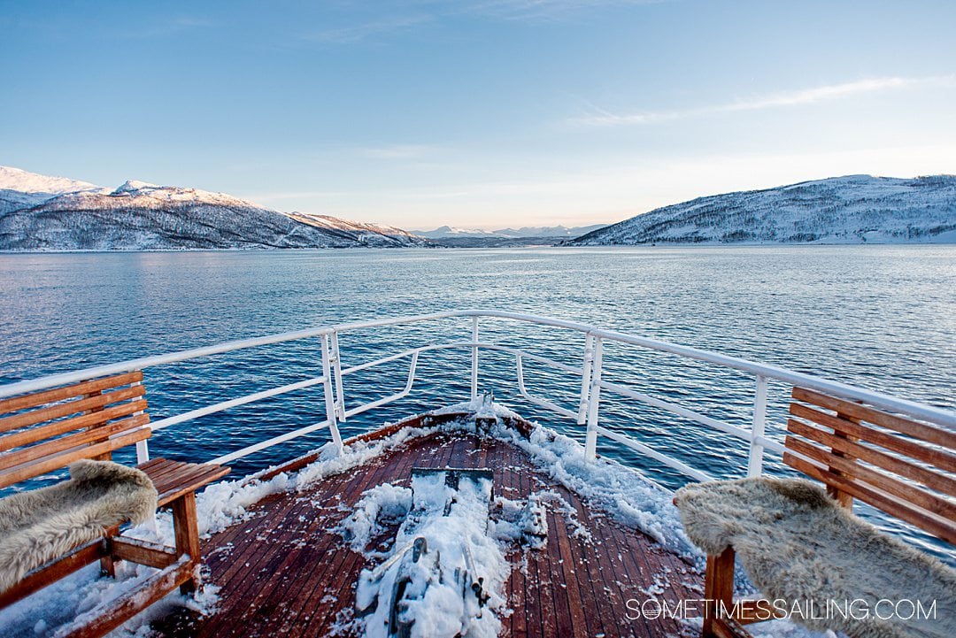 The bow of a ship on a Polar Fjord Boat Tour in Tromso, Norway with ice onboard.