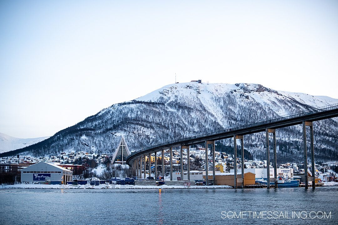 View of a bridge and Arctic cathedral as seen from a Tromso, Norway boat tour in the Arctic Circle.