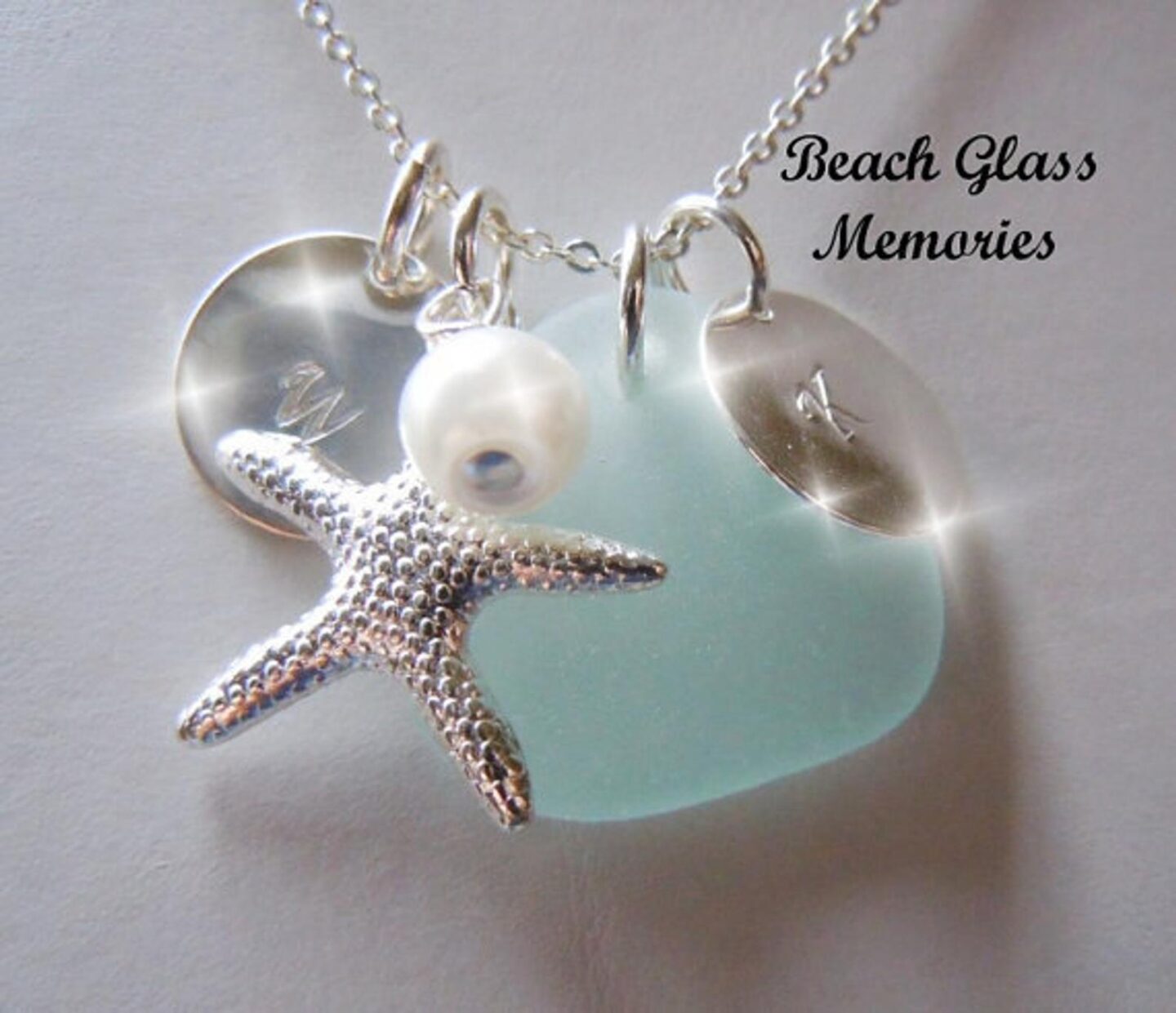 Beach glass jewelry from Etsy with a pearl, starfish and circle letter charm for great ideas for gifts for cruise lovers. 