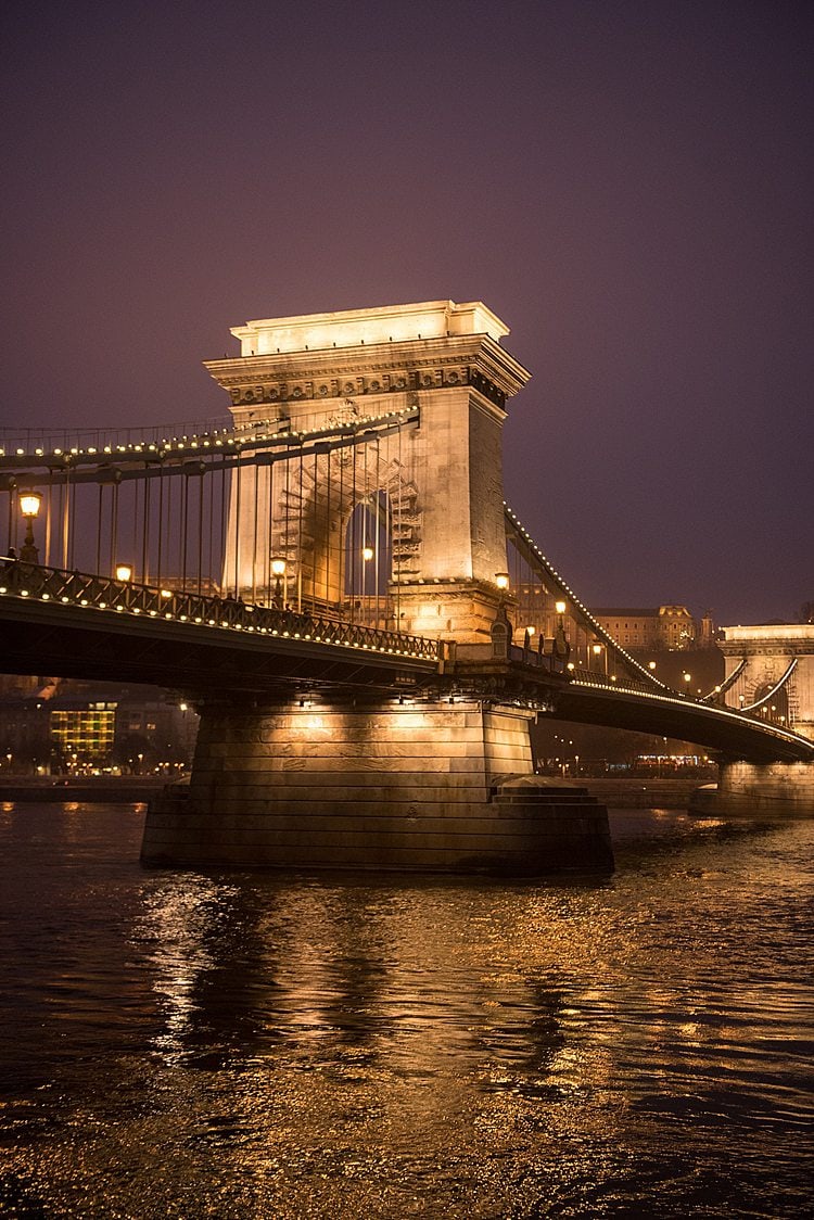Bridge in Budapest during night time, illuminated by lights for a Christmas Markets River Cruise post.