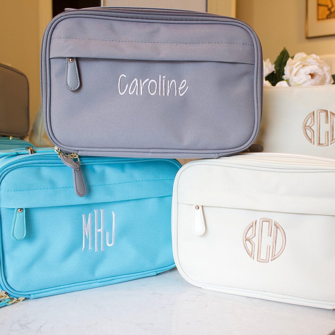 Grey, blue and white personalized toiletry cases.