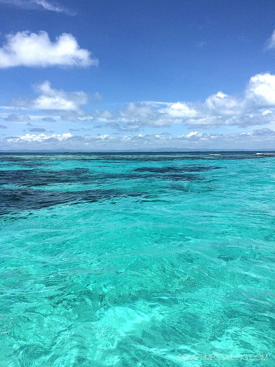 Blue sky with white clouds and turquoise water.