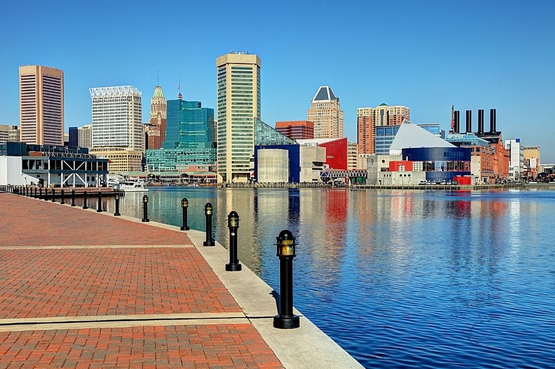 Inner Harbor in Baltimore with a view of the downtown Baltimore skyline in the distance.
