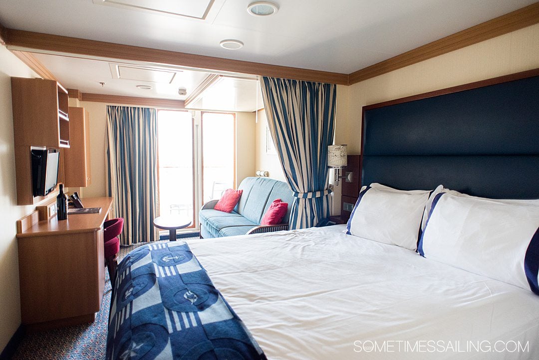 Interior of a cabin on the Disney Dream cruise line ship with blue and white bedding.