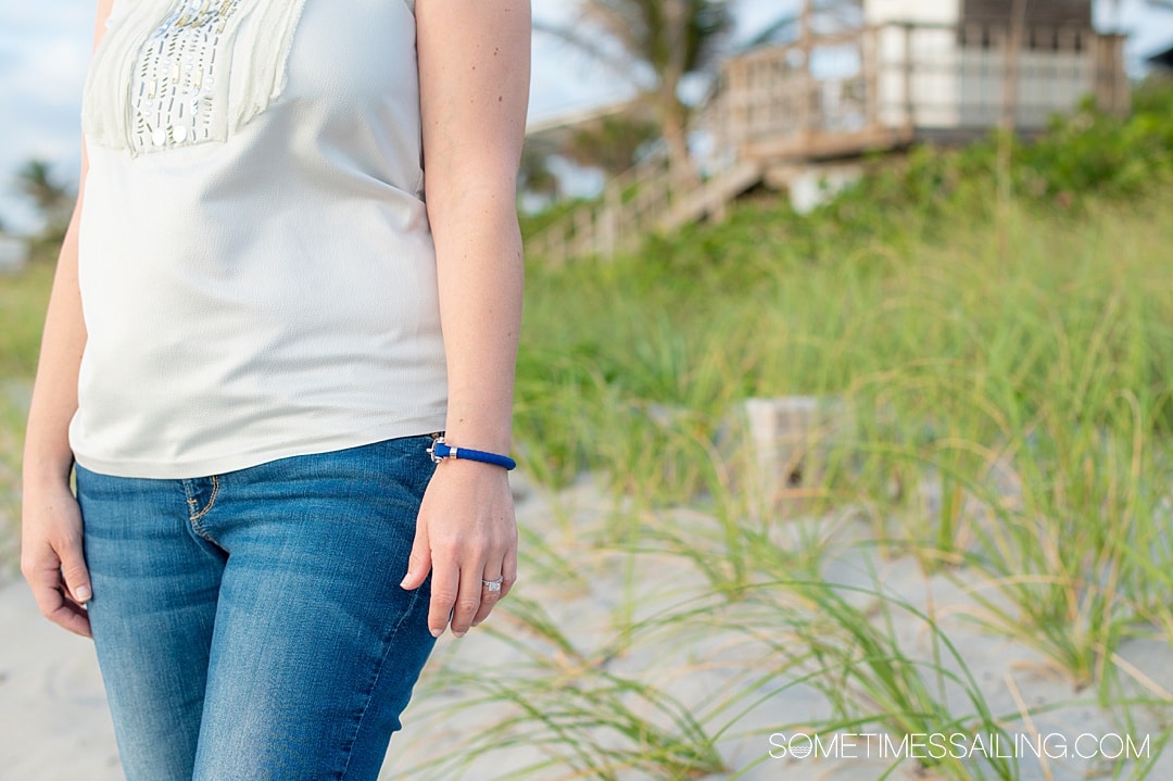 OMEGA sailing bracelet in blue rubber and stainless steel on a woman's wrist.