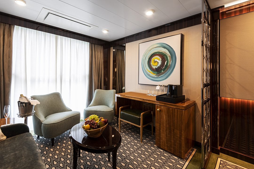 Horizon Stateroom lounge area on Atlas Ocean Voyages' World Navigator.