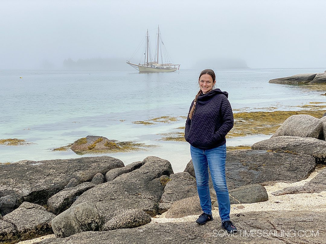 Woman on the shore of Russ Island during a Maine Windjammer Association cruise.