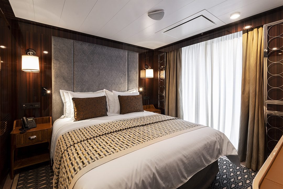 Navigator Suite bedroom on the World Navigator, Atlas Ocean Voyages lux-adventure cruise ship.