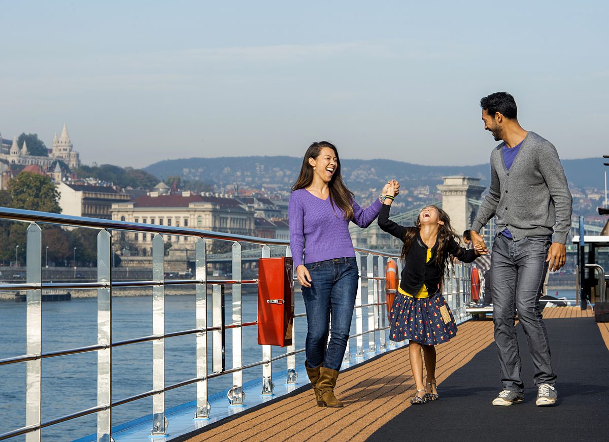 Family walking on the top deck of a river cruise ship.