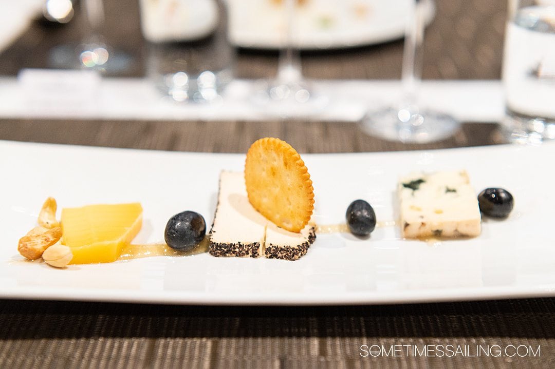 Plate of three cheese and a cracker in the center for dessert on Emerald Destiny, on a river cruise ship on the Danube River.
