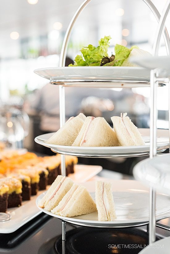 Three tiered plate with triangular tea sandwiches during tea time on the Emerald Destiny river cruise ship.