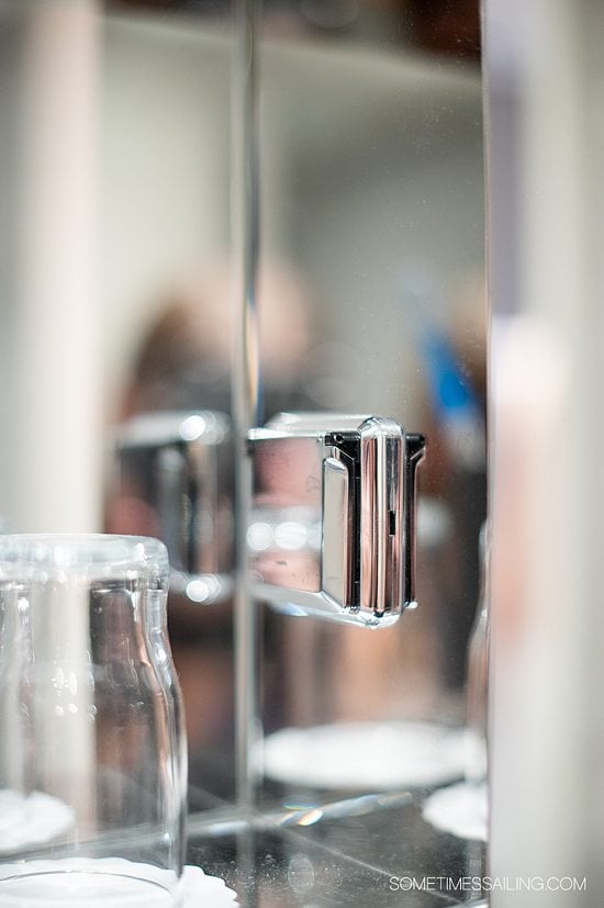 Silver reflective coating and mirror on the shelf of a bathroom in a river cruise ship stateroom with Emerald Cruises.