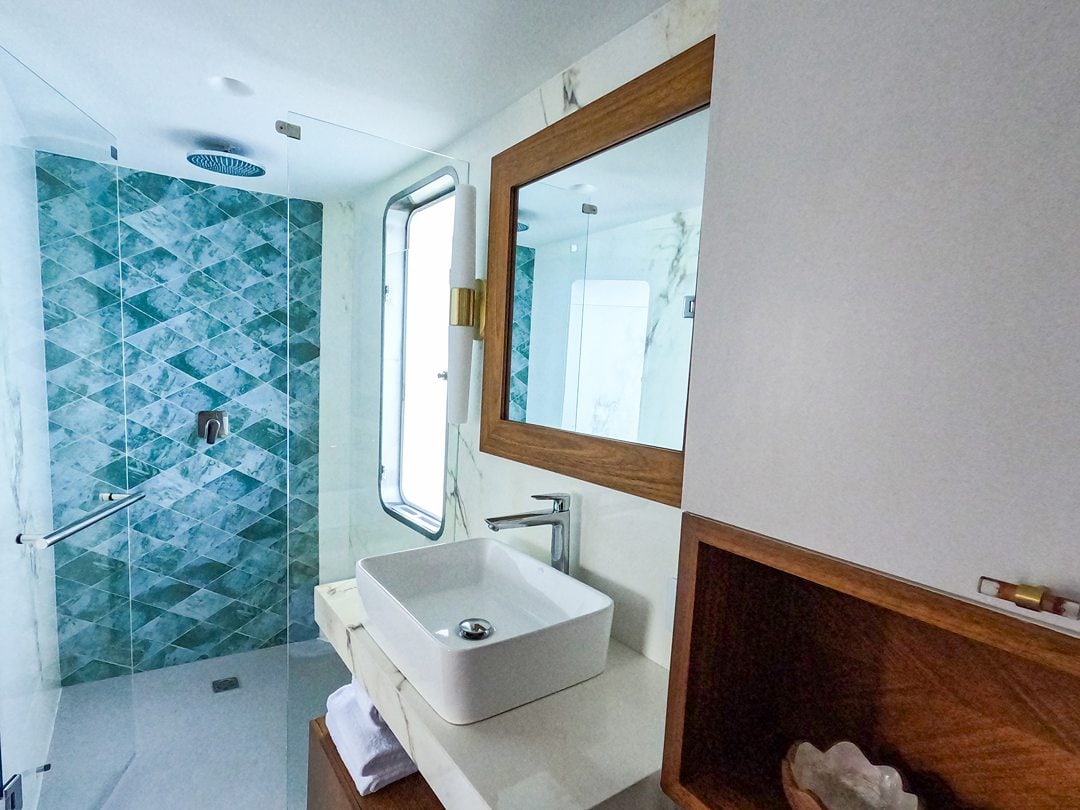 White and blue bathroom on a Kontiki Expeditions luxury yacht cruise ship that sails the coast of Ecuador.