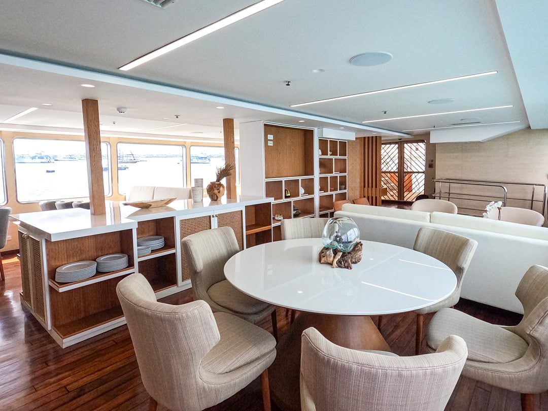 Kontiki Expeditions eating area with tables and chairs aboard the luxury yacht cruise that sails the coast of Ecuador.