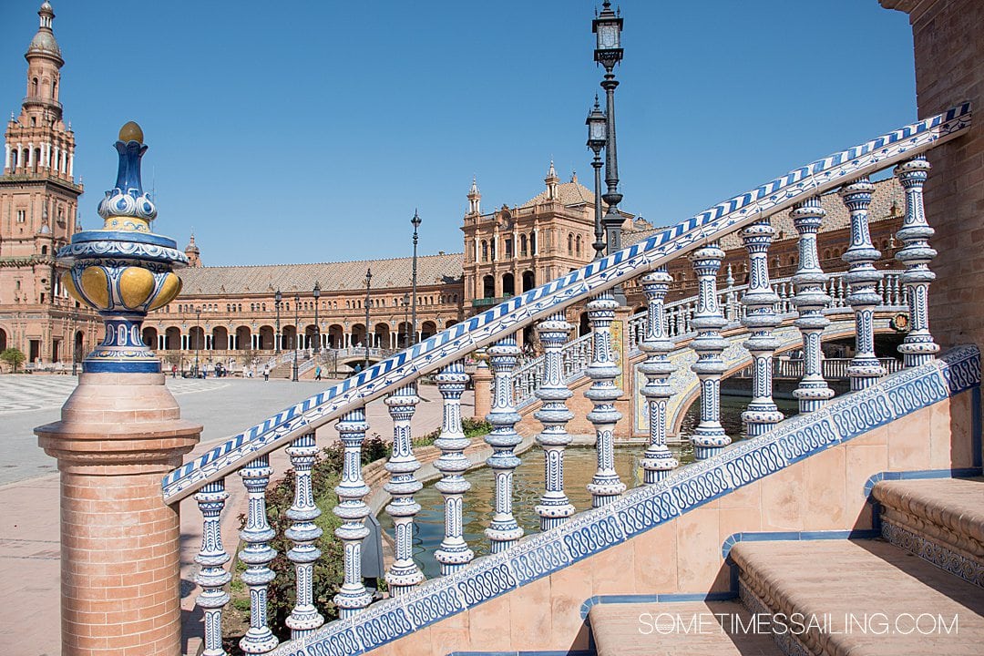 White columns with blue paint down stairs in Seville, Spain's Plaza de Espana.