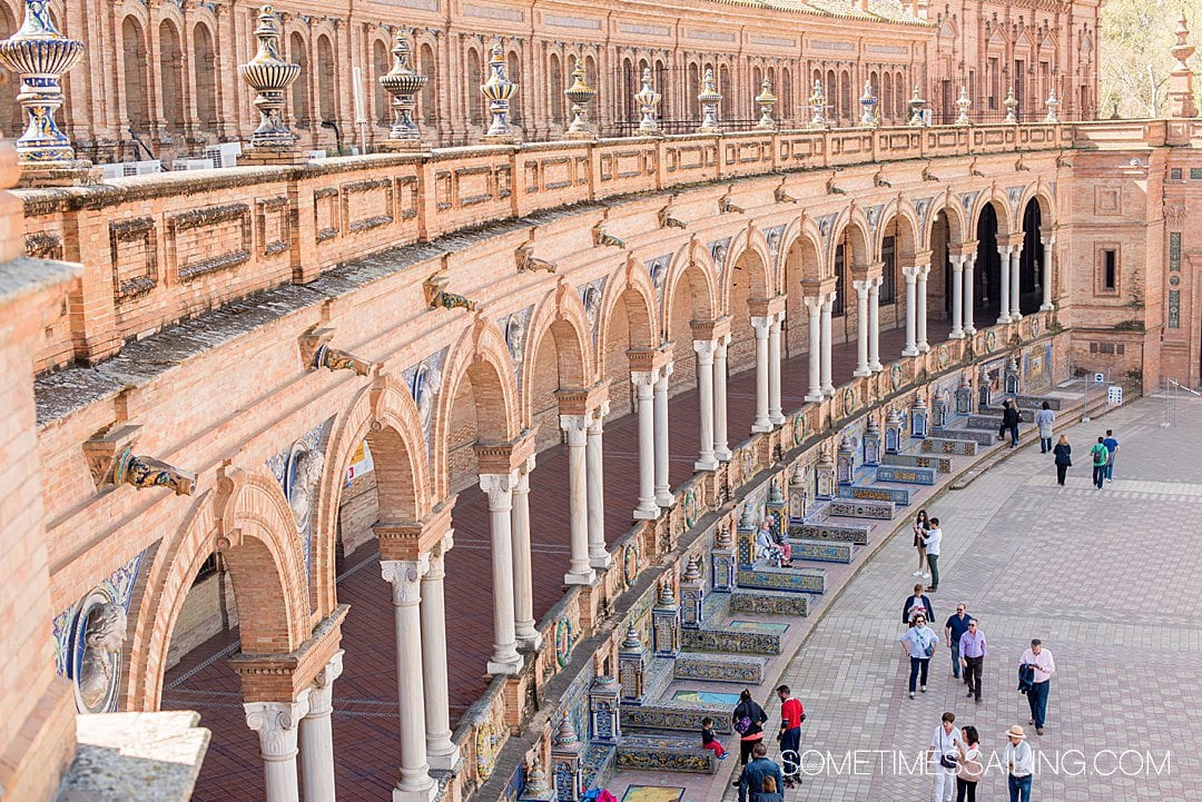Colonnades and brick of Plaza de Espana in Seville, Spain, taken from a second-story view.