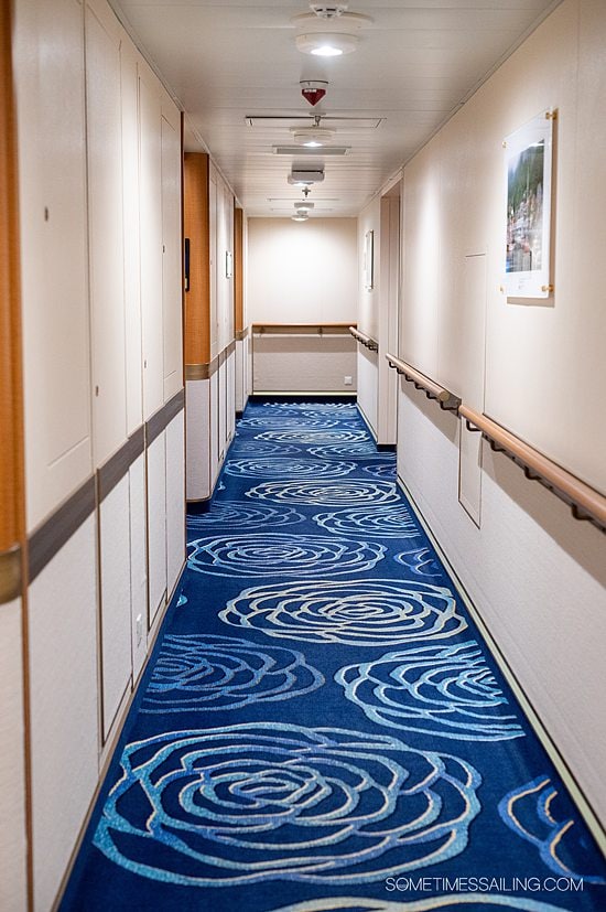 Blue carpet with a floral print on Majestic Princess cruise ship - helps a guest identify port vs starboard sides of the boat.