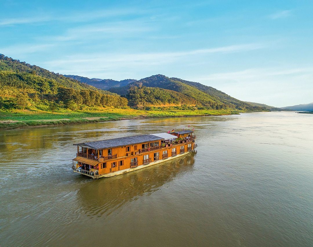 Wooden Mekong cruise ship on the river.