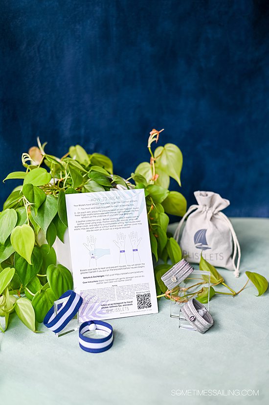 Blisslets anti-nausea wristbands in silver, blue and white stripes finishes with the packaging and info card.