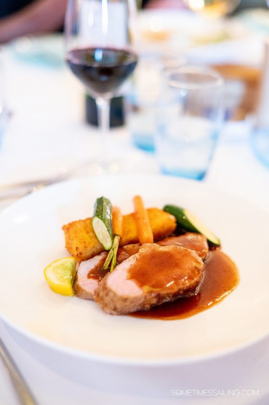 Port dish with gravy and carrots and zucchini vegetables on Viking Forseti in France.