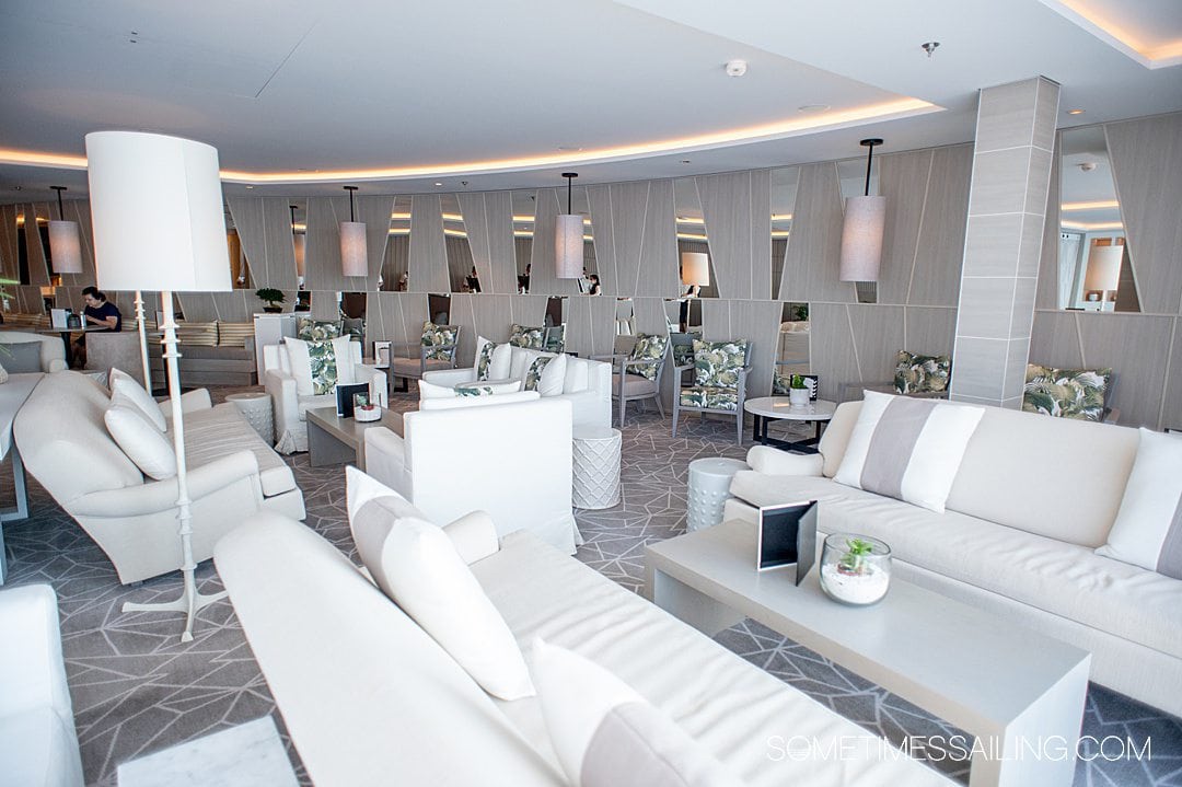 White couches in a The Retreat Lounge on Celebrity Apex cruise ship.