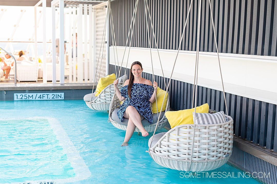 Woman on a swing in The Retreat pool on Celebrity Apex cruise ship.