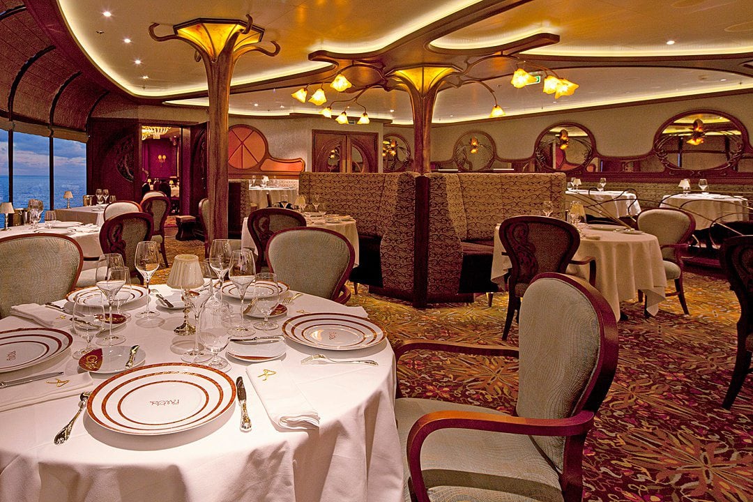 Dimly lit interior of Remy restaurant on Disney Cruise Line.