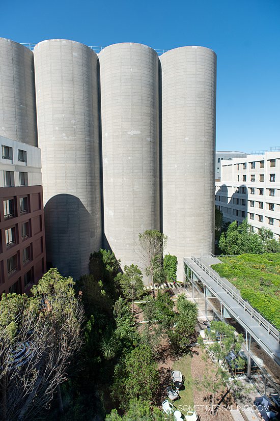 Industrial stacks and green living rooftop garden of The Renaissance Hotel in Bordeaux, France.