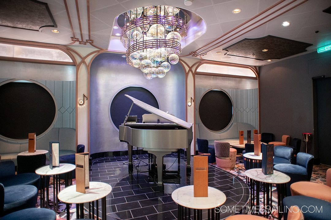 Grand piano under a "bubble" chandelier in Nightingale's on Disney Wish cruise ship.