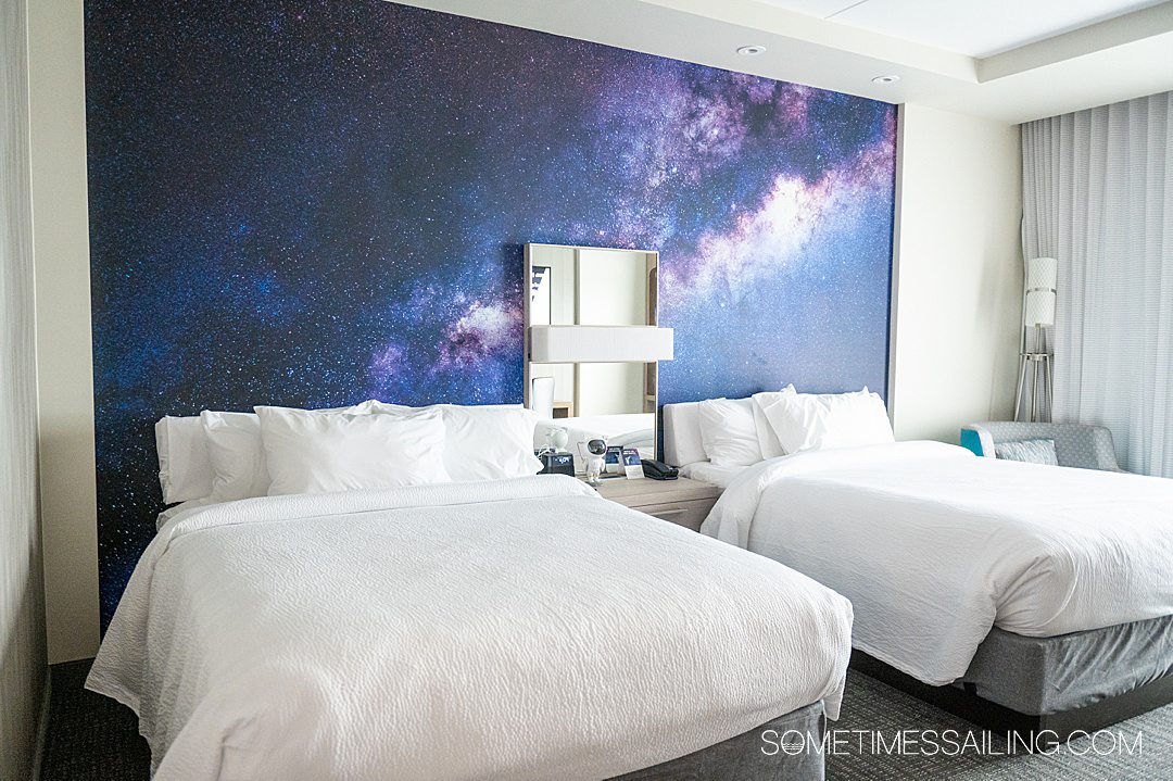 Galaxy photo in blue and purple behind the beds at a space hotel in Titusville Florida.