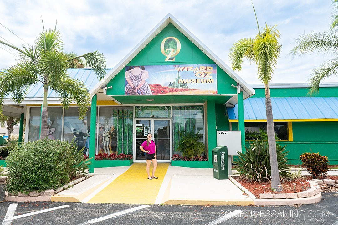 Women in front of a green building, that is the Wizard of Oz museum and a great thing to do near Port Canaveral.