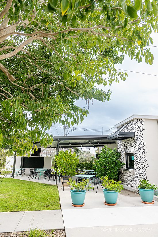 Things to do near Port Canaveral including eating at this restaurant with outdoor seating, under a blue sky and green trees in Titusville.