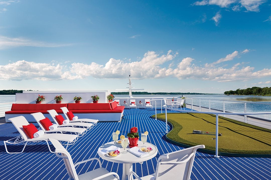 Sundeck of a Mississippi River cruise ship with blue flooring on the sundeck and a putting green.