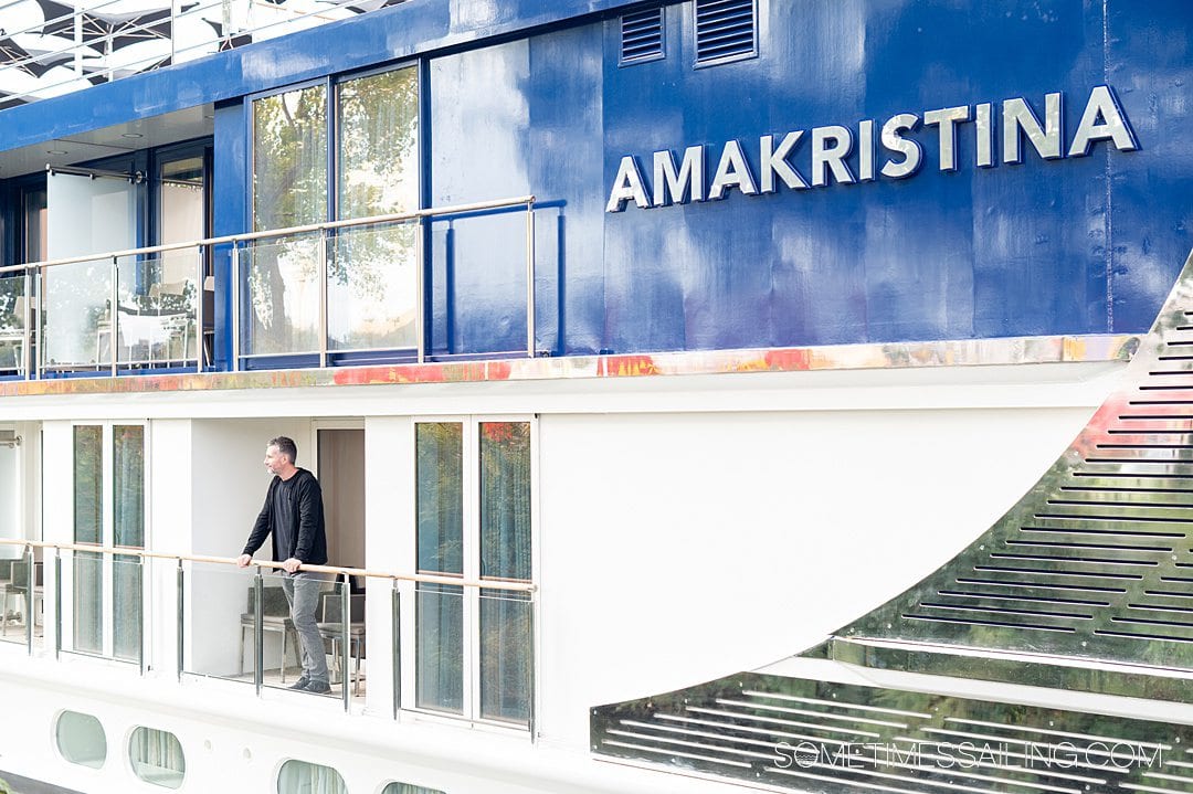 Man on the balcony of his stateroom on AmaKristina AmaWaterways river cruise ship.