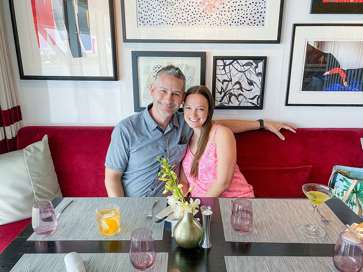 Couple sitting at a table at Luminae restaurant in The Retreat of Celebrity Apex cruise ship.