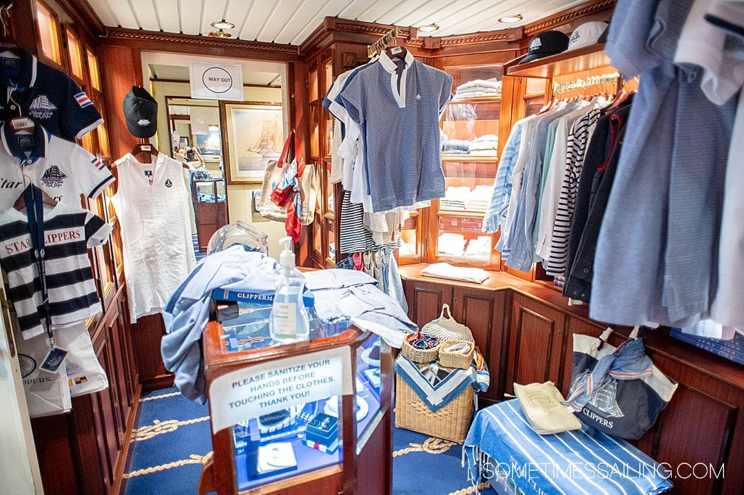 Small shop with apparel hanging up and a display case on Star Clippers sailing cruise ship.