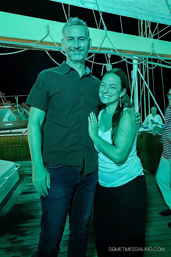 Man and woman in green lighting during the night on a cruise ship.