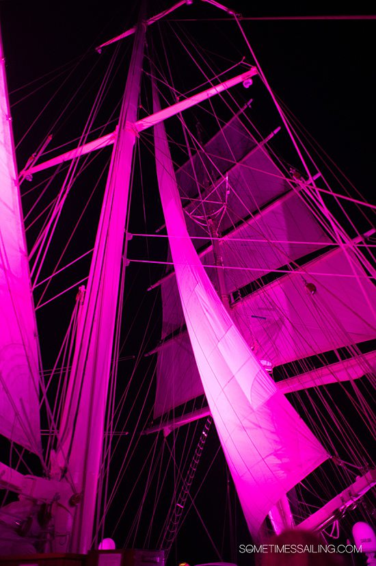 Pink illuminated sails during the night time on a cruise ship.