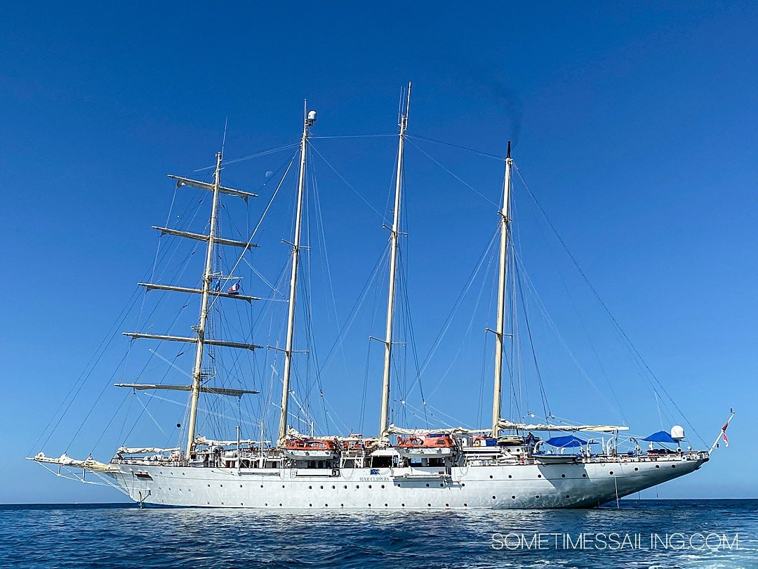 Star Clipper classic sailing cruise ship in the ocean with the sails down and masts sky-high.