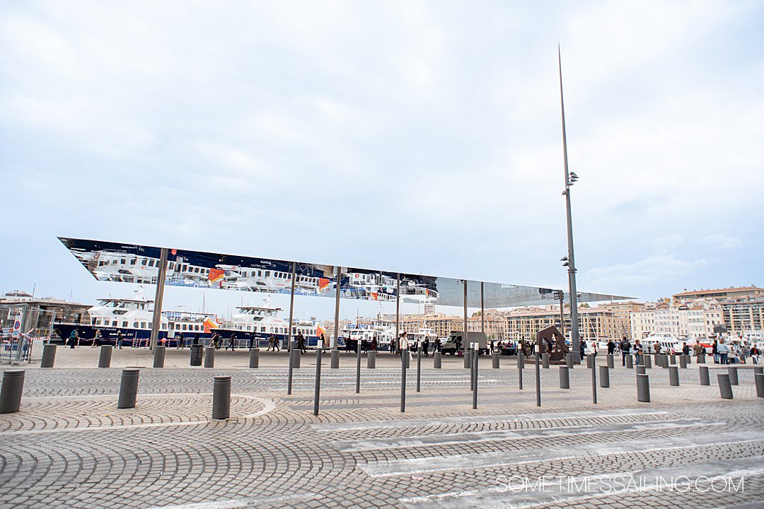 Vieux-Port, the old port in Marseille, with a crosswalk and mirror structure in the distance.