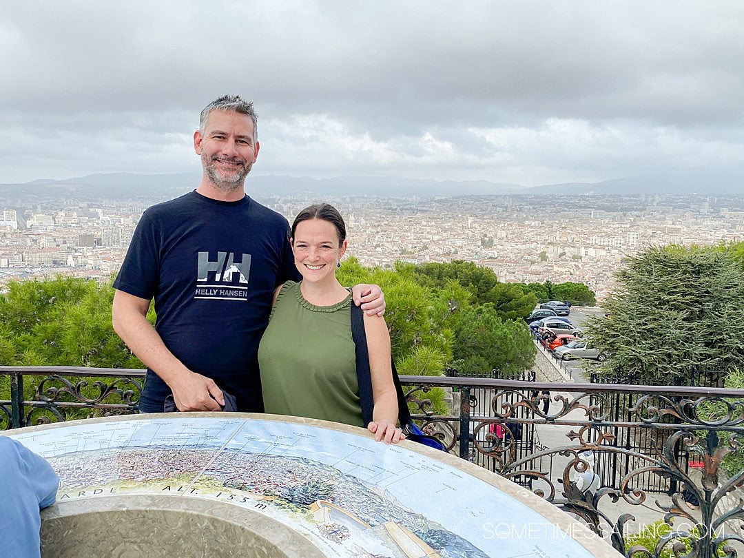 Panoramic view of Marseille from a hilltop with a couple in focus.