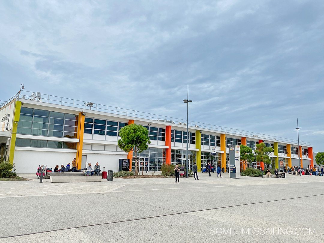 Colorful facade of the Marseille airport with red, orange and green striping.