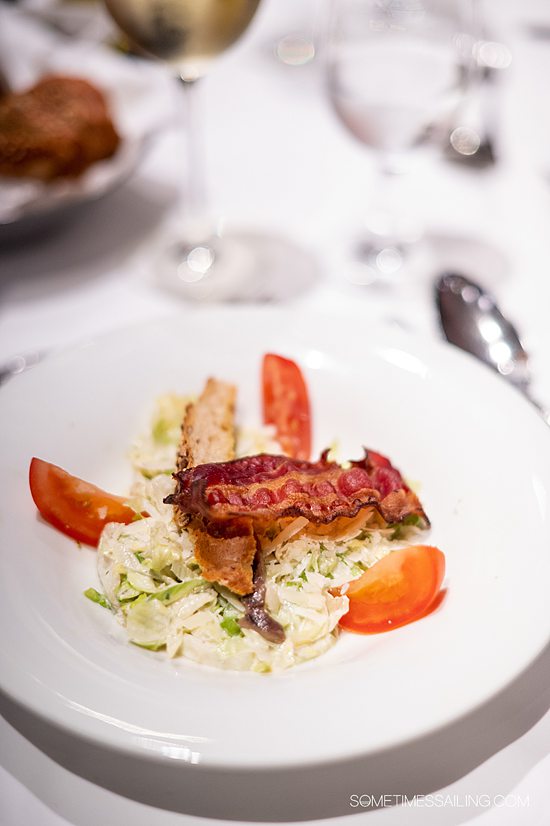 Dish of Caesar salad with bacon and tomatoes on an AmaWaterways river cruise.