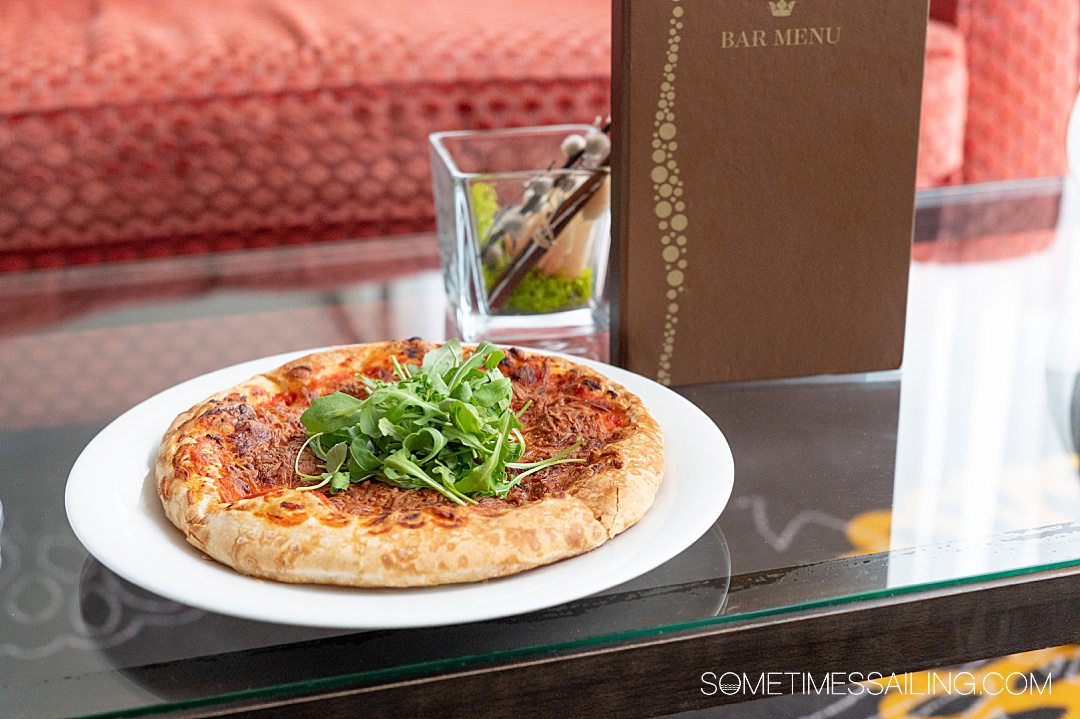 Small personal-sized pizza with arugula on top on an AmaWaterways river cruise.