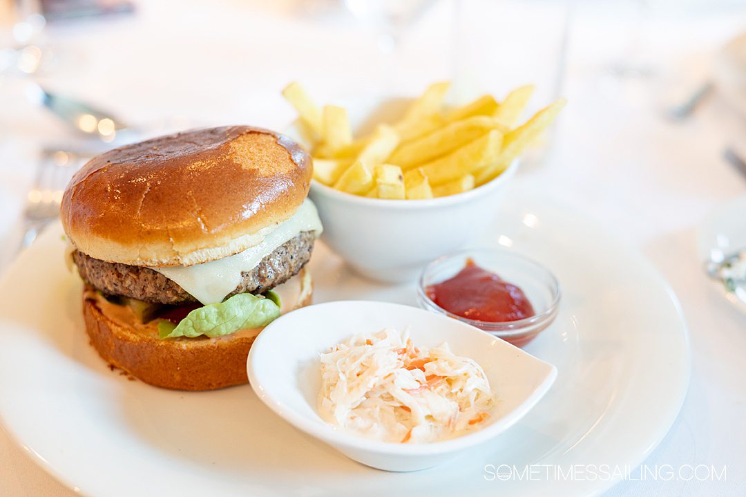 Cheeseburger, French fries, ketchup and coleslaw on a plate during an AmaWaterways river cruise.