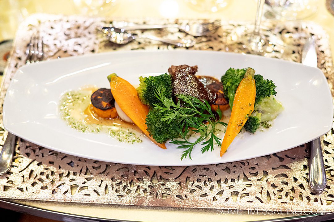 Meat and vegetables on a long oval plate for an AmaWaterways food review.