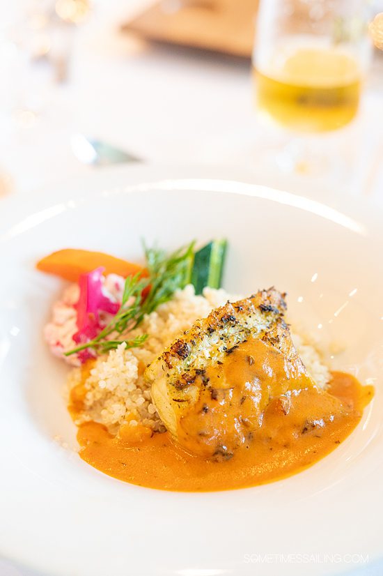 Fish and couscous with an orange sauce, for an AmaWaterways food review on a France river cruise.