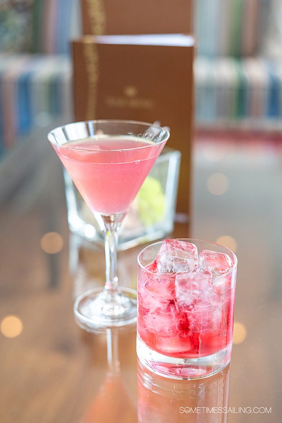 Two red-colored drinks in a martini glass and rocks glass aboard an AmaWaterways river cruise with beverages review.