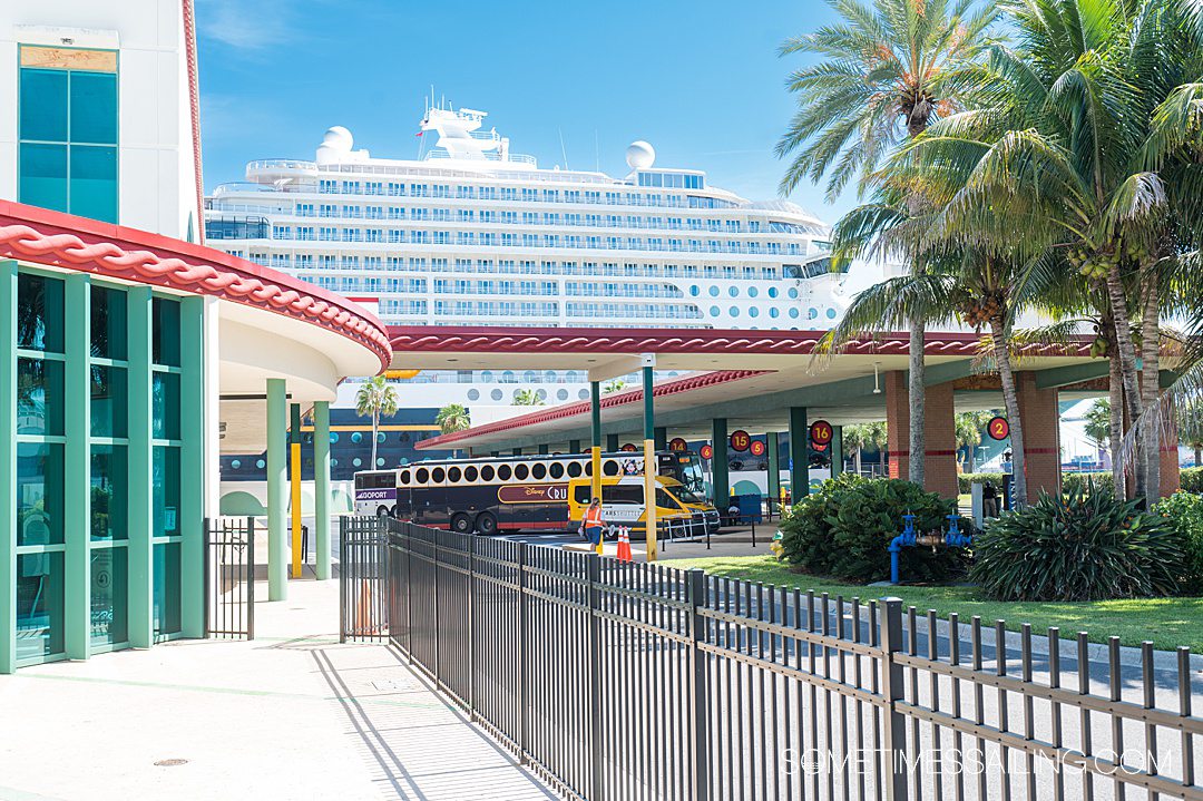 Disney Cruise Line ship in the distance at the Port Canaveral terminal, for what to expect for Disney Cruise Line embarkation day.